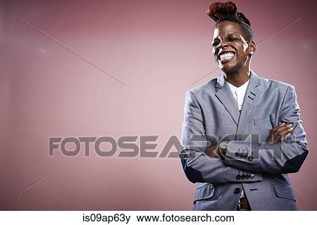 "Portrait of young woman, arms crossed, smiling" View Large Photo Image Stock Photo - "Portrait of young woman, arms crossed, smiling". Fotosearch