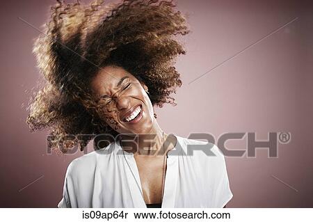 "Portrait of young woman flicking hair, smiling" View Large Photo Image Stock Photography - "Portrait of young woman flicking hair, smiling". Fotosearch
