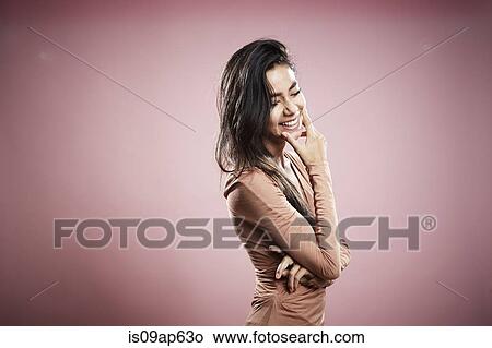 "Portrait of young woman, hand on chin, laughing" View Large Photo Image Picture - "Portrait of young woman, hand on chin, laughing". Fotosearch