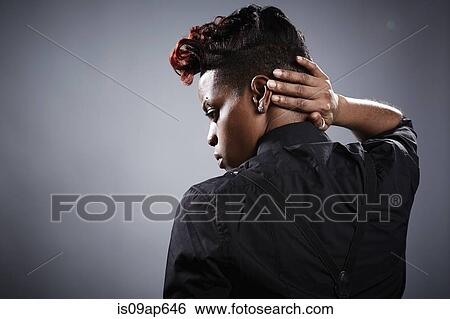 "Portrait of young woman, hand on neck, rear view" View Large Photo Image Stock Photograph - "Portrait of young woman, hand on neck, rear view". Fotosearch