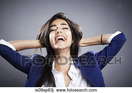 "Portrait of young woman, hands behind head, laughing" View Large Photo Image Stock Image - "Portrait of young woman, hands behind head, laughing". Fotosearch