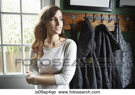 Portrait of young woman in cloakroom View Large Photo Image Stock Image - Portrait of young woman in cloakroom. Fotosearch