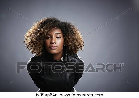 Portrait of young woman leaning into camera View Large Photo Image Picture - Portrait of young woman leaning into camera. Fotosearch