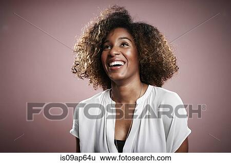 Stock Photograph - "Portrait of young woman, looking away, laughing". Fotosearch