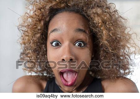 Portrait of young woman pulling a face with mouth open View Large Photo Image Stock Photo - Portrait of young woman pulling a face with mouth open. Fotosearch