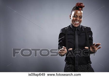 "Portrait of young woman, thumbs under trouser braces, laughing" View Large Photo Image Stock Photo - "Portrait of young woman, thumbs under trouser braces, laughing". Fotosearch