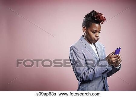Portrait of young woman using smartphone View Large Photo Image Stock Photograph - Portrait of young woman using smartphone. Fotosearch