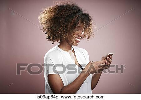 Stock Photography - Portrait of young woman using smartphone. Fotosearch