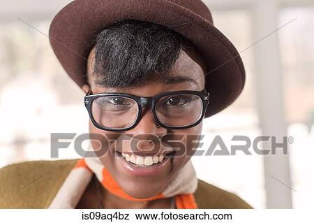 Stock Photo - Portrait of young woman wearing felt hat. Fotosearch