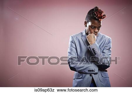 Portrait of young woman with hand on chin and thoughtful expression View Large Photo Image Stock Photo - Portrait of young woman with hand on chin and thoughtful expression. Fotosearch