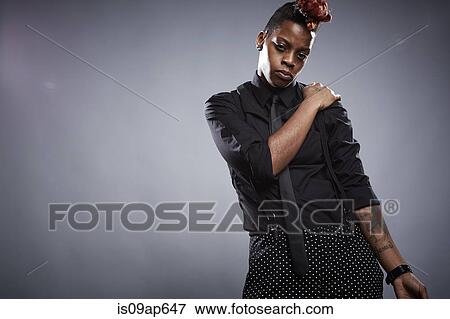 Portrait of young woman with hand on shoulder and serious expression View Large Photo Image Stock Photo - Portrait of young woman with hand on shoulder and serious expression. Fotosearch