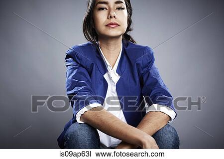 Portrait of young woman with serious expression View Large Photo Image Stock Image - Portrait of young woman with serious expression. Fotosearch