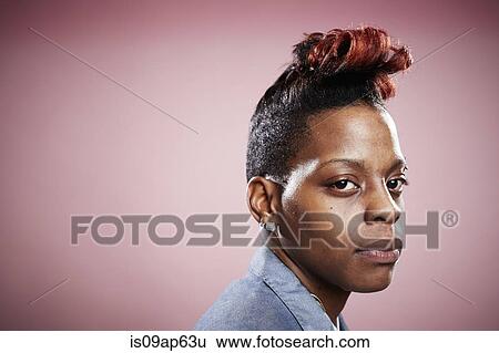 Portrait of young woman with serious expression View Large Photo Image Stock Photograph - Portrait of young woman with serious expression. Fotosearch