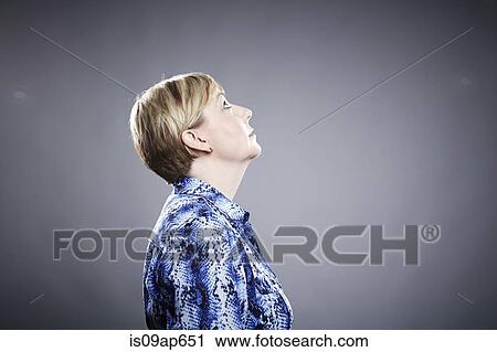 Stock Image - "Profile of mature woman, looking up". Fotosearch