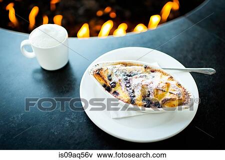 Pudding and coffee by restaurant open fire View Large Photo Image Stock Photo - Pudding and coffee by restaurant open fire. Fotosearch