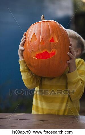 Stock Image - Pumpkin carving for Halloween. Fotosearch