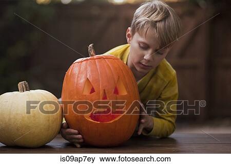 Stock Photo - Pumpkin carving for Halloween. Fotosearch