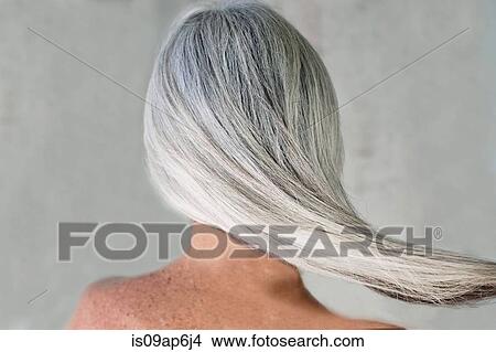 Picture - Rear view of bare shouldered mature woman with long grey hair. Fotosearch