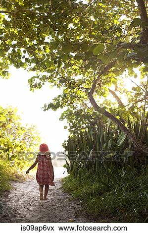"Rear view of barefoot girl in sunhat walking along woodland beach path, Anna Maria Island, Florida, USA" View Large Photo Image Stock Photo - "Rear view of barefoot girl in sunhat walking along woodland beach path, Anna Maria Island, Florida, USA". Fotosearch