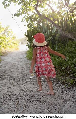 "Rear view of barefoot girl in sunhat walking on woodland beach path, Anna Maria Island, Florida, USA" View Large Photo Image Stock Photo - "Rear view of barefoot girl in sunhat walking on woodland beach path, Anna Maria Island, Florida, USA". Fotosearch