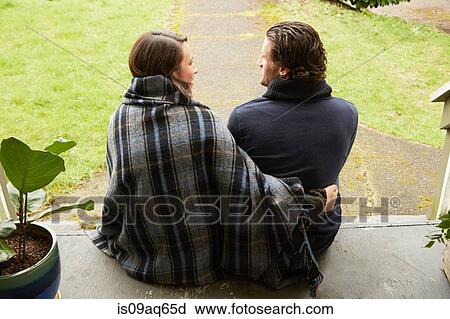 Rear view of young couple sitting on porch step View Large Photo Image Stock Image - Rear view of young couple sitting on porch step. Fotosearch