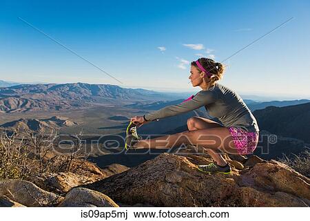 "Rear view of young female trail runner crouching and touching toes, Pacific Crest Trail, Pine Valley, California, USA" View Large Photo Image Stock Image - "Rear view of young female trail runner crouching and touching toes, Pacific Crest Trail, Pine Valley, California, USA". Fotosearch