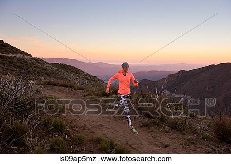 "Rear view of young woman trail running down dirt track at dusk on Pacific Crest Trail, Pine Valley, California, USA" View Large Photo Image Stock Photo - "Rear view of young woman trail running down dirt track at dusk on Pacific Crest Trail, Pine Valley, California, USA". Fotosearch