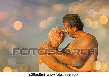 Senior couple hugging on holiday View Large Photo Image Stock Image - Senior couple hugging on holiday. Fotosearch