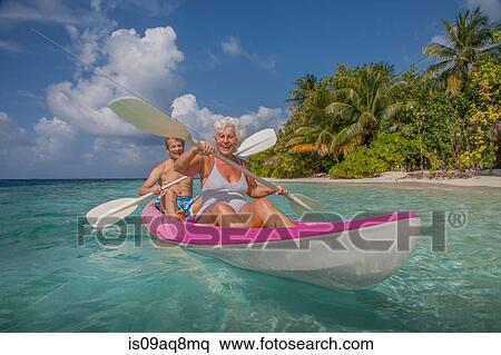 Stock Photography - "Senior couple in canoe, Maldives". Fotosearch