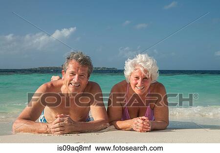 "Senior couple lying on beach, Maldives" View Large Photo Image Stock Image - "Senior couple lying on beach, Maldives". Fotosearch