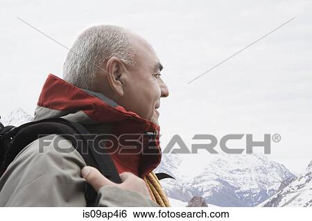 Stock Photograph - "Senior male mountain climber, looking at view". Fotosearch