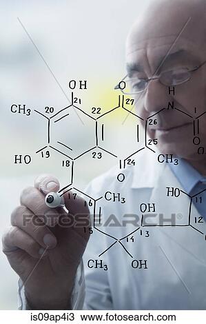 Stock Image - Senior male scientist writing molecular formula on clear board. Fotosearch