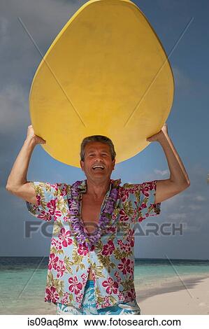 "Senior man holding surfboard, portrait" View Large Photo Image Stock Photo - "Senior man holding surfboard, portrait". Fotosearch
