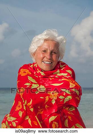Stock Photo - "Senior woman wrapped in shawl, portrait". Fotosearch