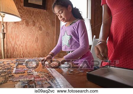 Sisters doing a puzzle on summer vacation View Large Photo Image Stock Image - Sisters doing a puzzle on summer vacation. Fotosearch