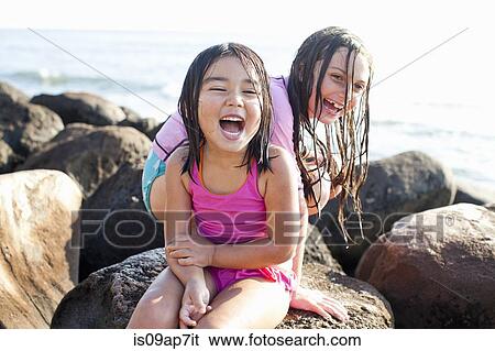 "Sisters playing on beach, Maui, Hawaii, US" View Large Photo Image Stock Photograph - "Sisters playing on beach, Maui, Hawaii, US". Fotosearch