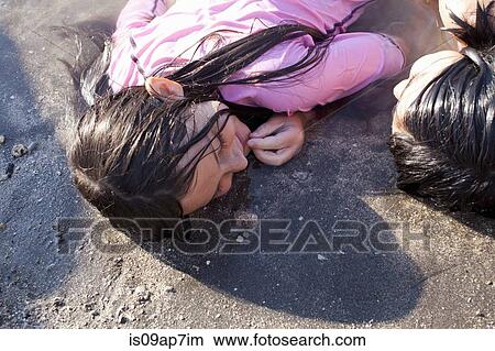 Picture - Sisters playing on beach. Fotosearch