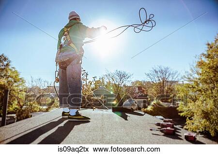 Solar panel installation crew member on roof of house View Large Photo Image Stock Photo - Solar panel installation crew member on roof of house. Fotosearch