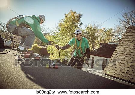 Solar panel installation crew members on roof of house View Large Photo Image Stock Photo - Solar panel installation crew members on roof of house. Fotosearch