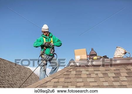 Solar panel installation worker on roof of house View Large Photo Image Stock Photograph - Solar panel installation worker on roof of house. Fotosearch