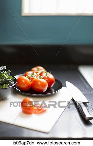 "Still life of tomatoes, kale and knife on table" View Large Photo Image Picture - "Still life of tomatoes, kale and knife on table". Fotosearch