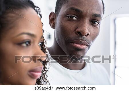Studio portrait of confident mid adult man next to girlfriend View Large Photo Image Stock Photo - Studio portrait of confident mid adult man next to girlfriend. Fotosearch