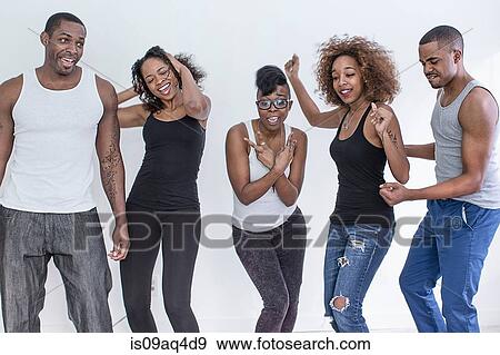 Stock Photo - Studio portrait of five adult friends dancing. Fotosearch