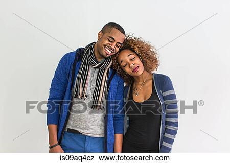 Studio portrait of romantic couple with heads on each others shoulder View Large Photo Image Stock Photo - Studio portrait of romantic couple with heads on each others shoulder. Fotosearch