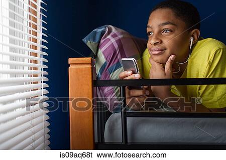 Teenage boy lying in bunkbed looking out of window View Large Photo Image Stock Photograph - Teenage boy lying in bunkbed looking out of window. Fotosearch