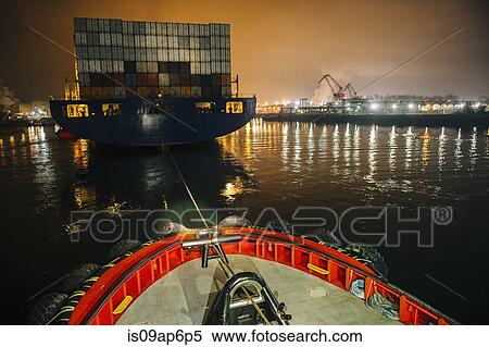 "Tugboat manoeuvring cargo ship in harbor at night, Tacoma, Washington, USA" View Large Photo Image Stock Photography - "Tugboat manoeuvring cargo ship in harbor at night, Tacoma, Washington, USA". Fotosearch
