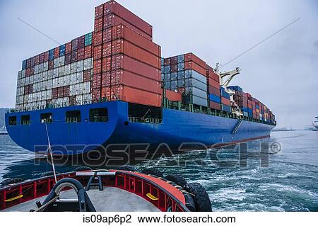 "Tugboat manoeuvring container ship on river, Tacoma, Washington, USA" View Large Photo Image Stock Image - "Tugboat manoeuvring container ship on river, Tacoma, Washington, USA". Fotosearch