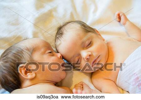 Stock Image - Twin baby sister and brother. Fotosearch