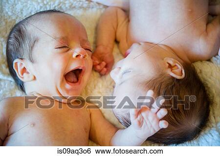 Stock Photograph - Twin baby sister and brother. Fotosearch