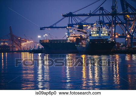 "View of cargo ships and gantry cranes in harbor at night, Tacoma, Washington, USA" View Large Photo Image Stock Image - "View of cargo ships and gantry cranes in harbor at night, Tacoma, Washington, USA". Fotosearch